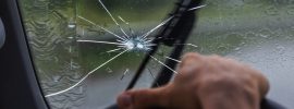 Broken windshield of a car in a dallas hailstorm