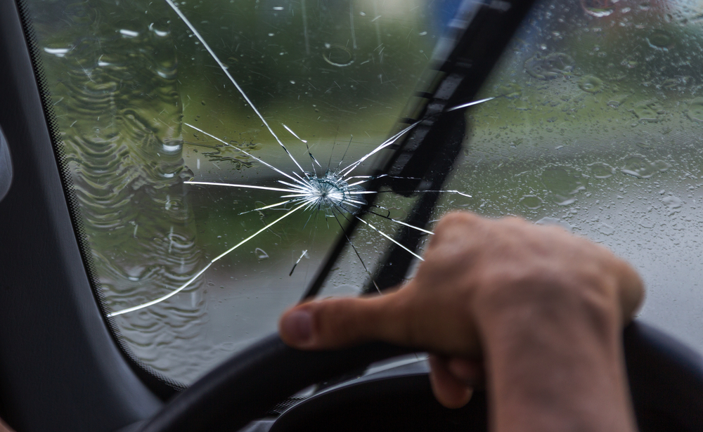 Broken windshield of a car in a dallas hailstorm